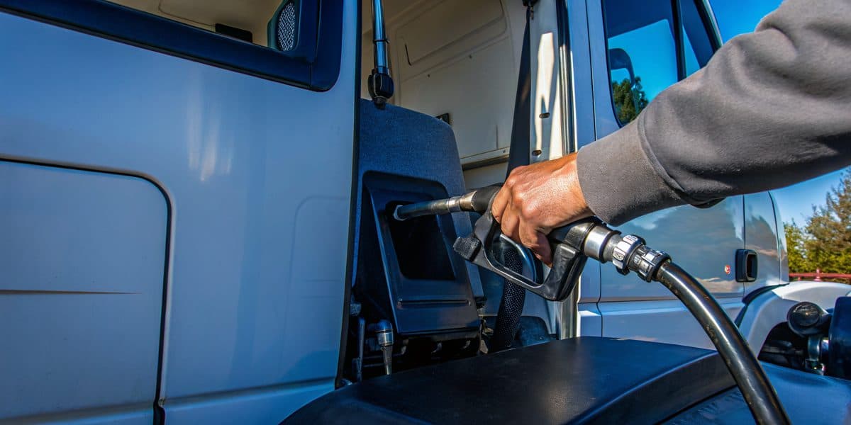 A fleet vehicle being refueled with gasoline at a station